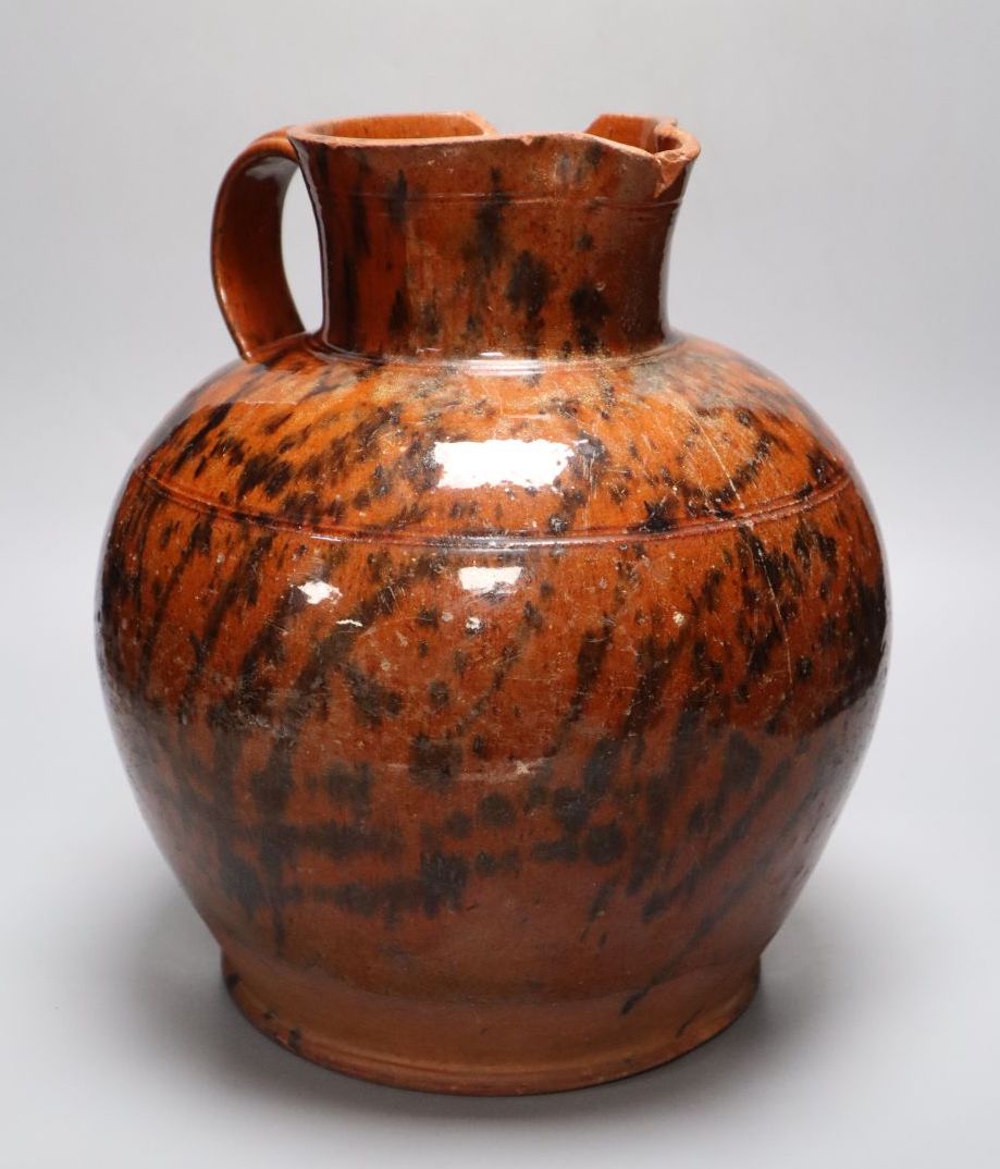 A 19th century Sussex terracotta jug, with black striped glaze, height 30cm (a.f.)
